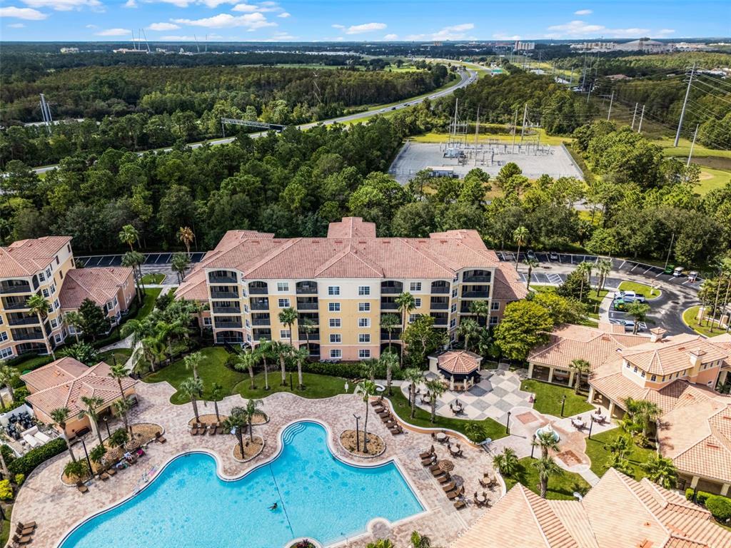 8801 Worldquest Boulevard, Unit 4108 Orlando, FL 32821 - Photo 62 of 85 a view of a patio with furniture and a garden