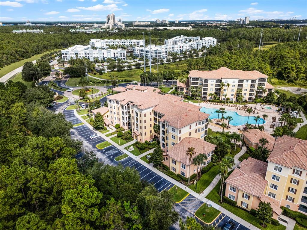 8801 Worldquest Boulevard, Unit 4108 Orlando, FL 32821 - Photo 66 of 85 an aerial view of a city with lots of residential buildings ocean and mountain view in back