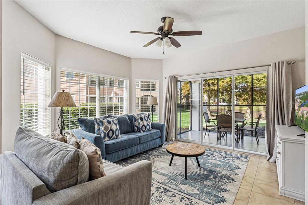 8801 Worldquest Boulevard, Unit 4108 Orlando, FL 32821 - Photo 7 of 85 a living room with furniture and a large window