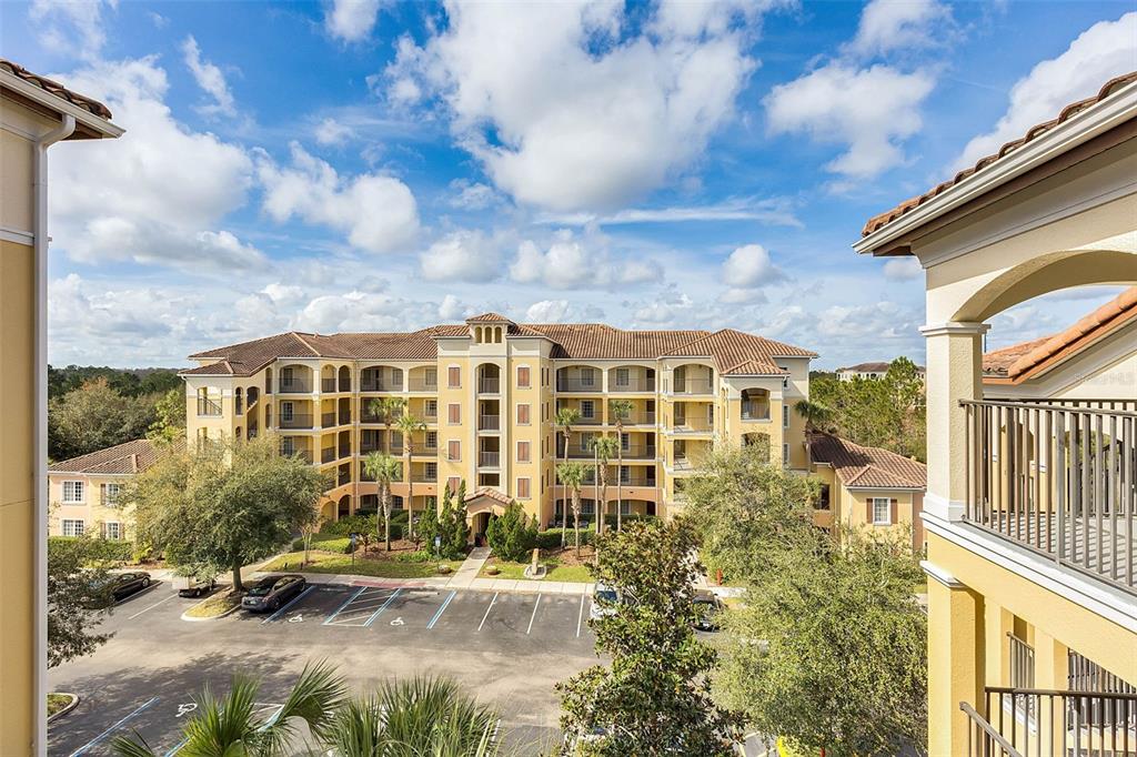 8801 Worldquest Boulevard, Unit 4108 Orlando, FL 32821 - Photo 76 of 85 a view of a blue building with swimming pool in front of it