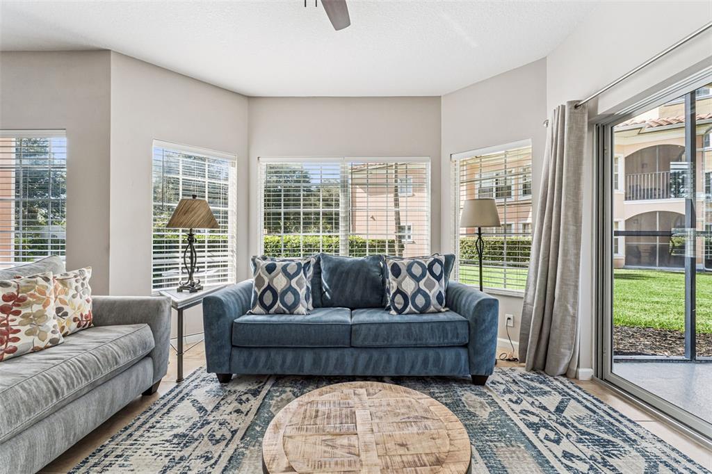 8801 Worldquest Boulevard, Unit 4108 Orlando, FL 32821 - Photo 8 of 85 a living room with furniture and a large window
