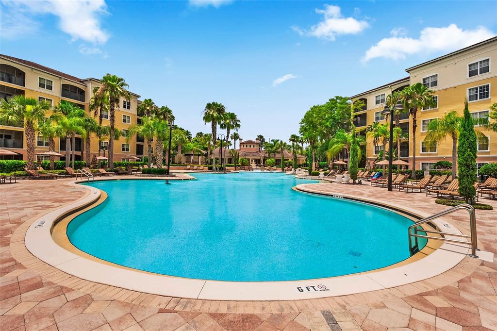 8801 Worldquest Boulevard, Unit 4108 Orlando, FL 32821 - Photo 84 of 85 a view of a swimming pool with outdoor seating