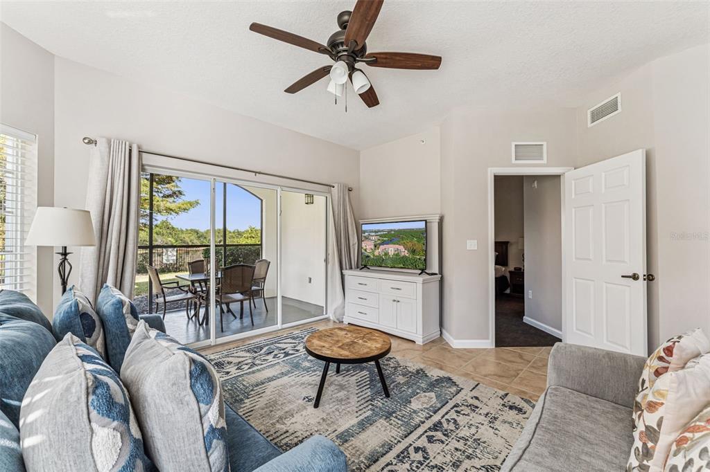 8801 Worldquest Boulevard, Unit 4108 Orlando, FL 32821 - Photo 9 of 85 a living room with furniture a rug and a large window
