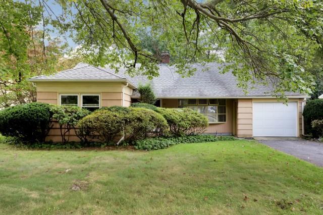 35 Vine Road Stamford, CT 06905 - Photo 1 of 1 a front view of a house with a garden and yard