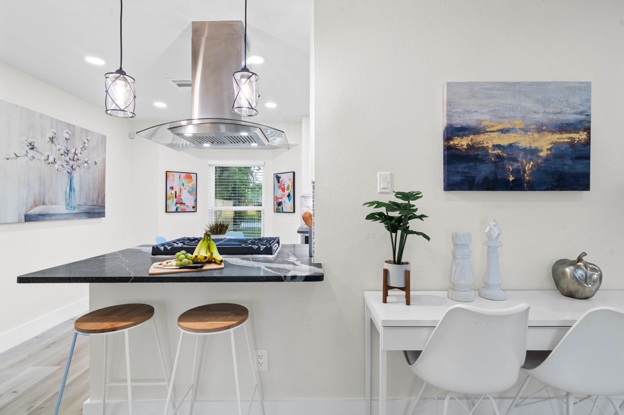 3138 Sunbeam Street Houston, TX 77051 - Photo 15 of 50 A stylish chef-inspired island, designer pendant lighting, and intimate seating create a kitchen space that feels both luxurious and functional.