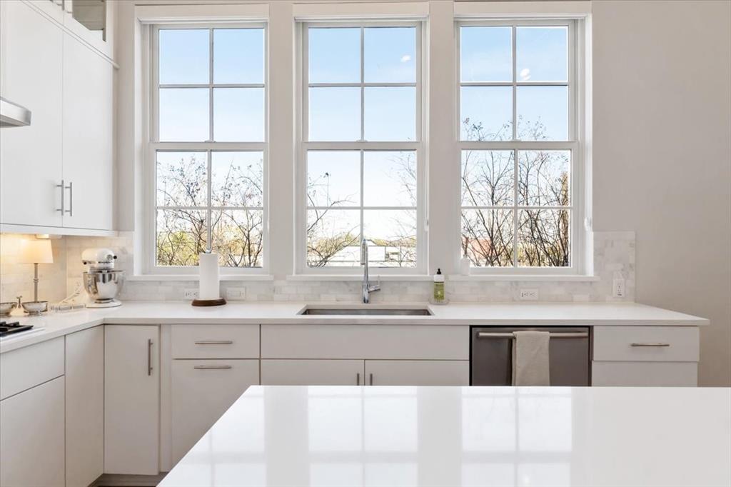 4129 Runyon Road Addison, TX 75001 - Photo 11 of 38 Kitchen featuring white cabinetry, dishwasher, glass fronted cabinets, and decorative backsplash