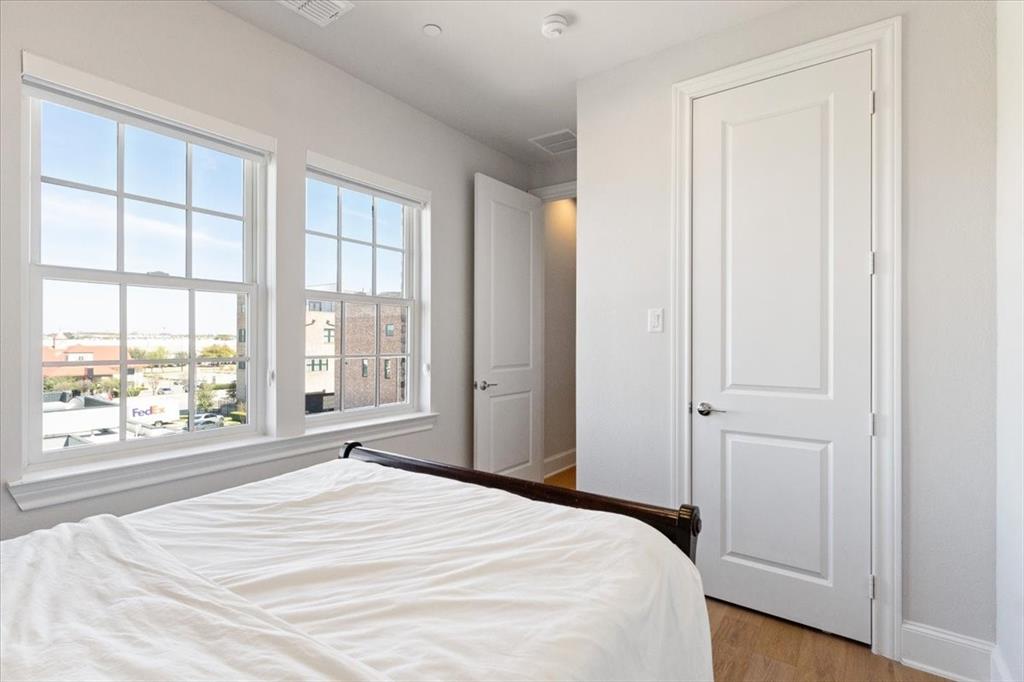 4129 Runyon Road Addison, TX 75001 - Photo 30 of 38 Bedroom featuring light wood finished floors and baseboards