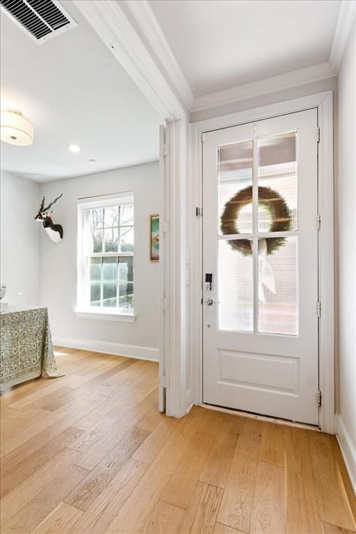4129 Runyon Road Addison, TX 75001 - Photo 3 of 38 Foyer featuring light wood finished floors and crown molding