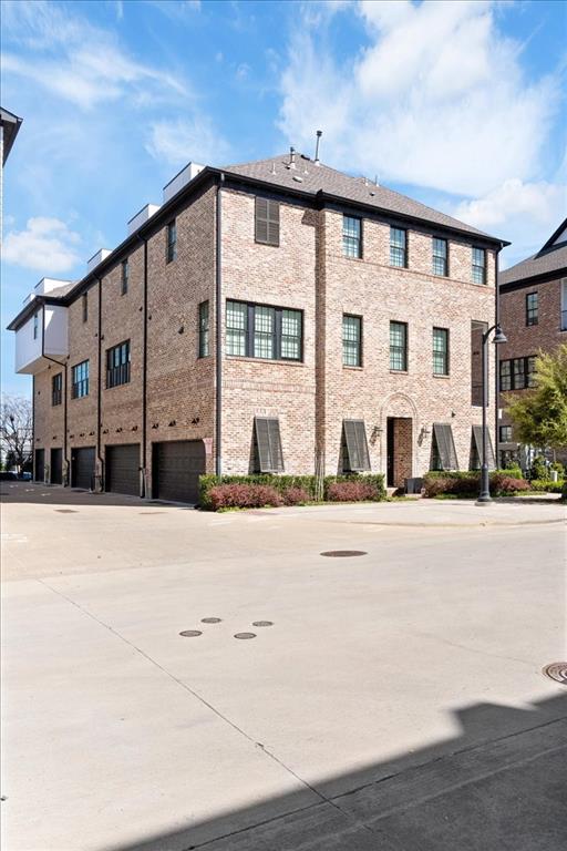 4129 Runyon Road Addison, TX 75001 - Photo 32 of 38 View of apartment building / complex with a garage and driveway