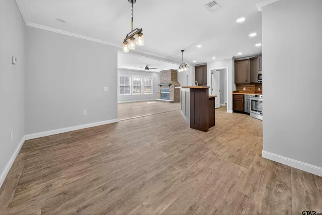 a view of a kitchen and refrigerator in a room