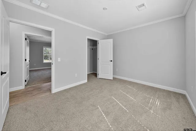 a view of an empty room and closet area