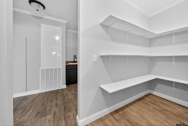 a view of an empty room with wooden floor