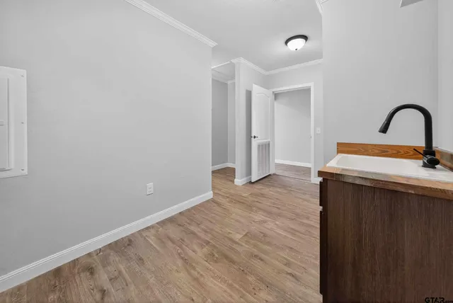 a view of a sink and dishwasher with wooden floor