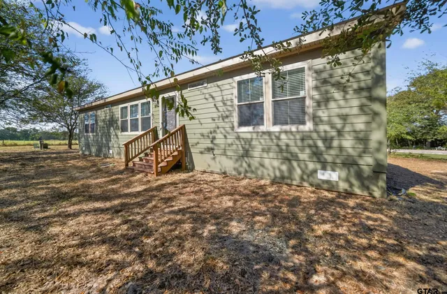 a pathway of a house with a yard