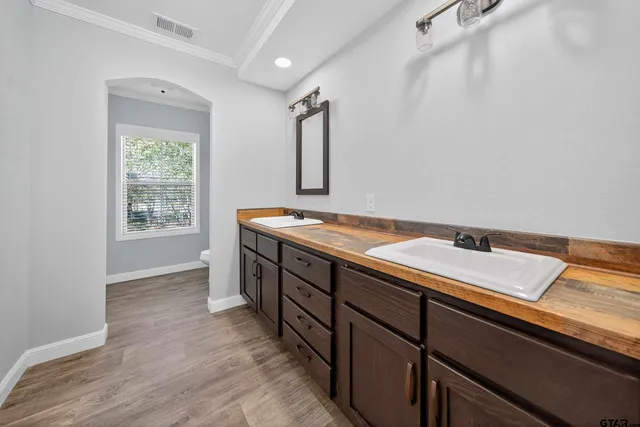 a spacious bathroom with a granite countertop sink and a mirror