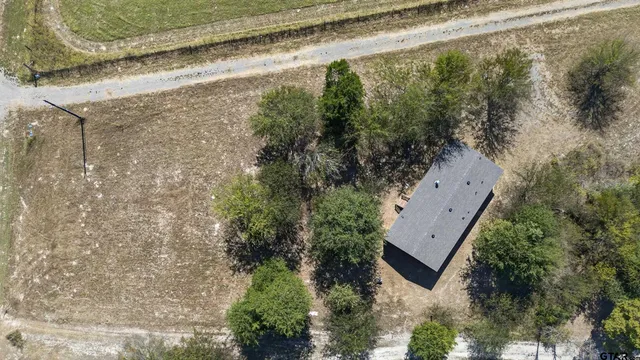 an aerial view of ocean and residential houses with outdoor space