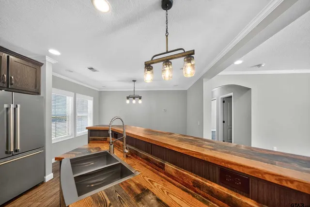 a living room with stainless steel appliances granite countertop furniture a rug and a window