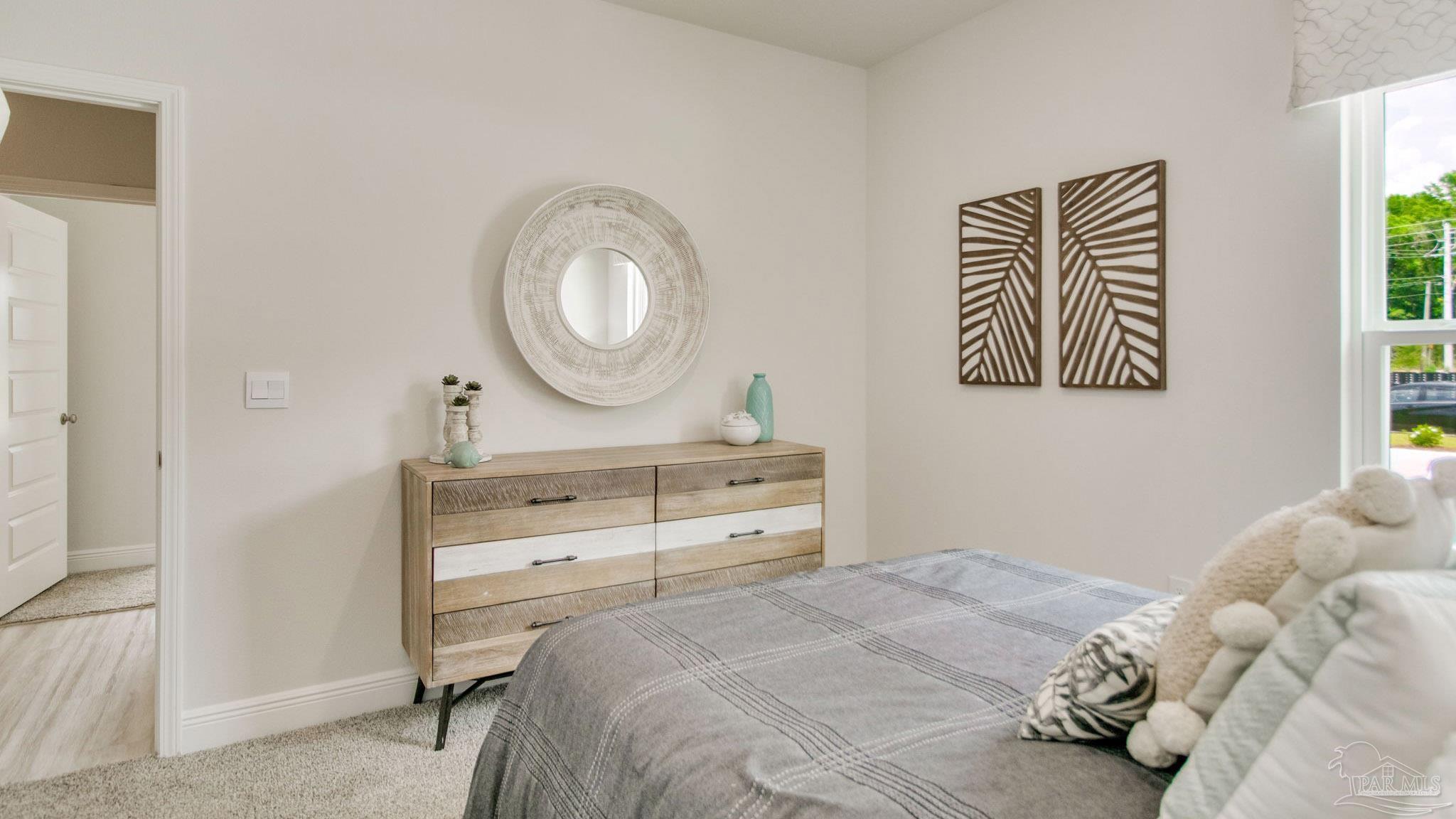 2796 Chevy Circle Pace, FL 32571 - Photo 27 of 31 a bedroom with a bed and a mirror