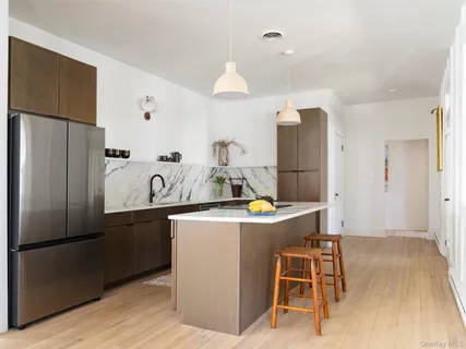 a kitchen with kitchen island a refrigerator stove and microwave