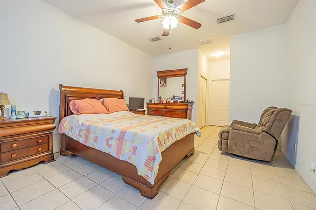 a spacious bedroom with a bed and closet