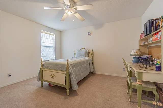 a bedroom with a bed and a table in it