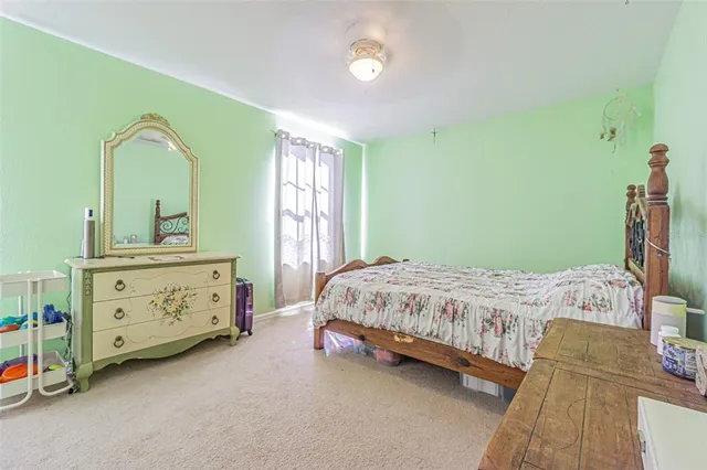 a bedroom with a bed and a dresser