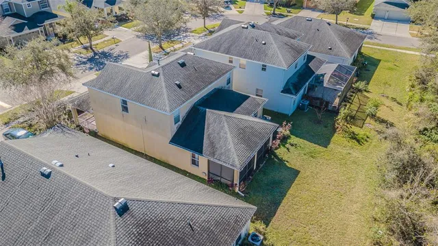 an aerial view of residential houses with outdoor space