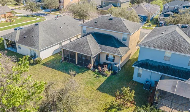 an aerial view of a house with a yard