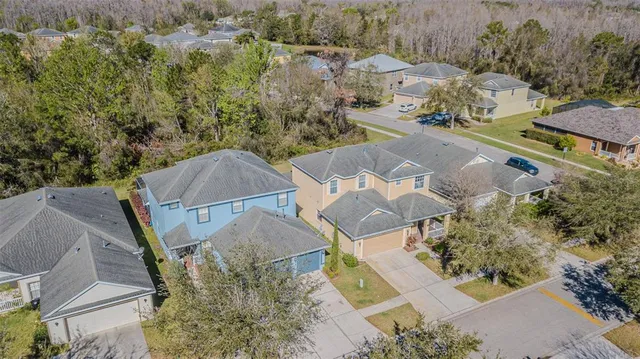 an aerial view of a house with a yard