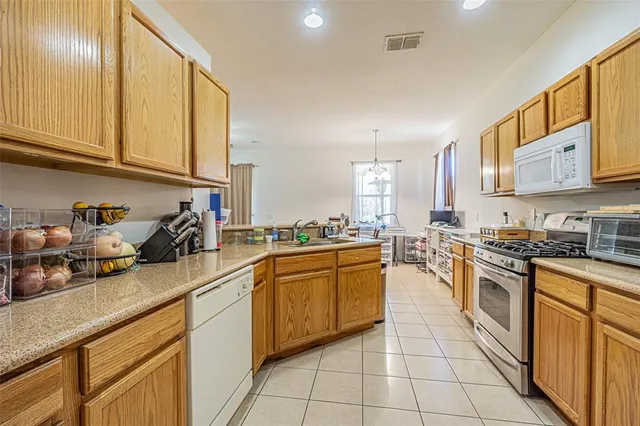 a kitchen with stainless steel appliances granite countertop a sink and cabinets