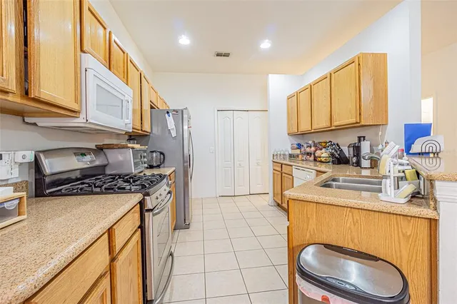 a kitchen with a sink a stove and cabinets