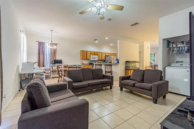 a living room with furniture and a chandelier