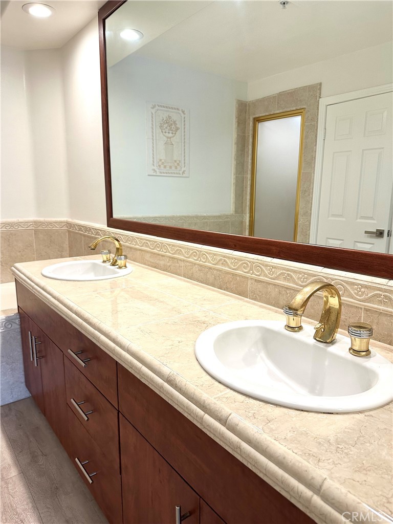 2243 Martin, Unit 117 Irvine, CA 92612 - Photo 12 of 16 a bathroom with a sink and a mirror