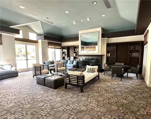 a living room with furniture fireplace and a large window