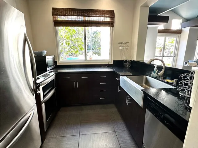 a kitchen with a sink appliances and cabinets