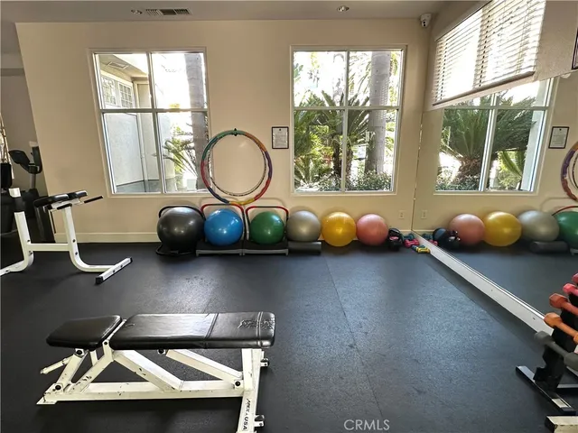 a room with wooden floor and windows