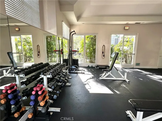 a room with gym equipment and a large window