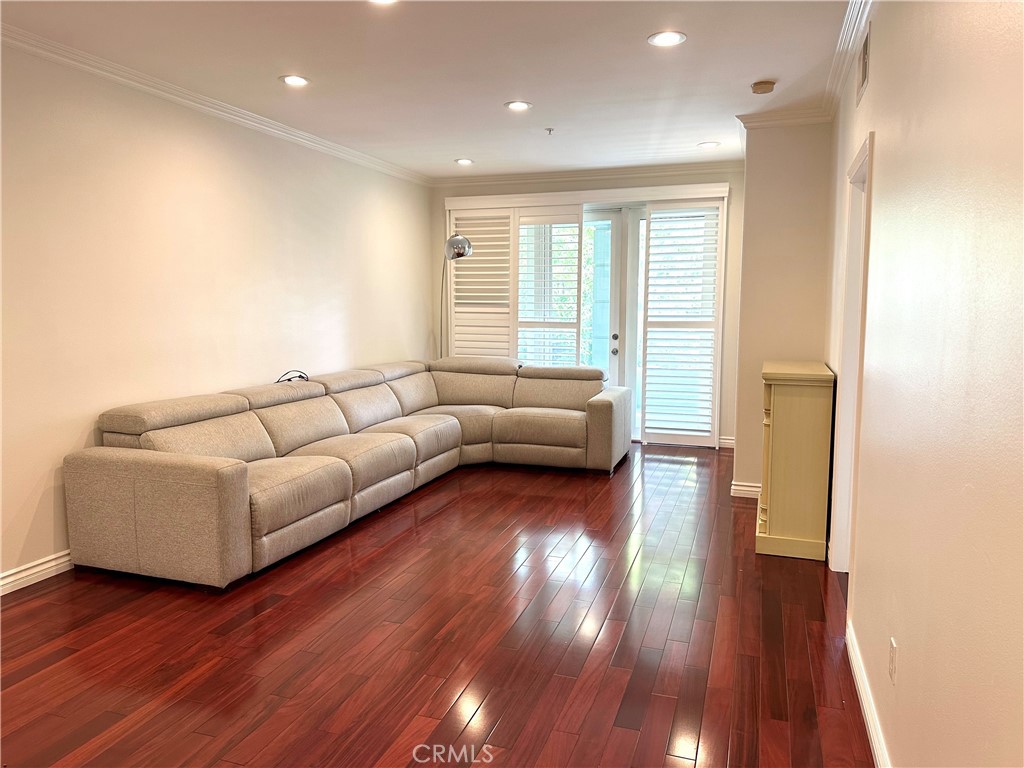 2243 Martin, Unit 117 Irvine, CA 92612 - Photo 10 of 16 a living room with furniture and a wooden floor