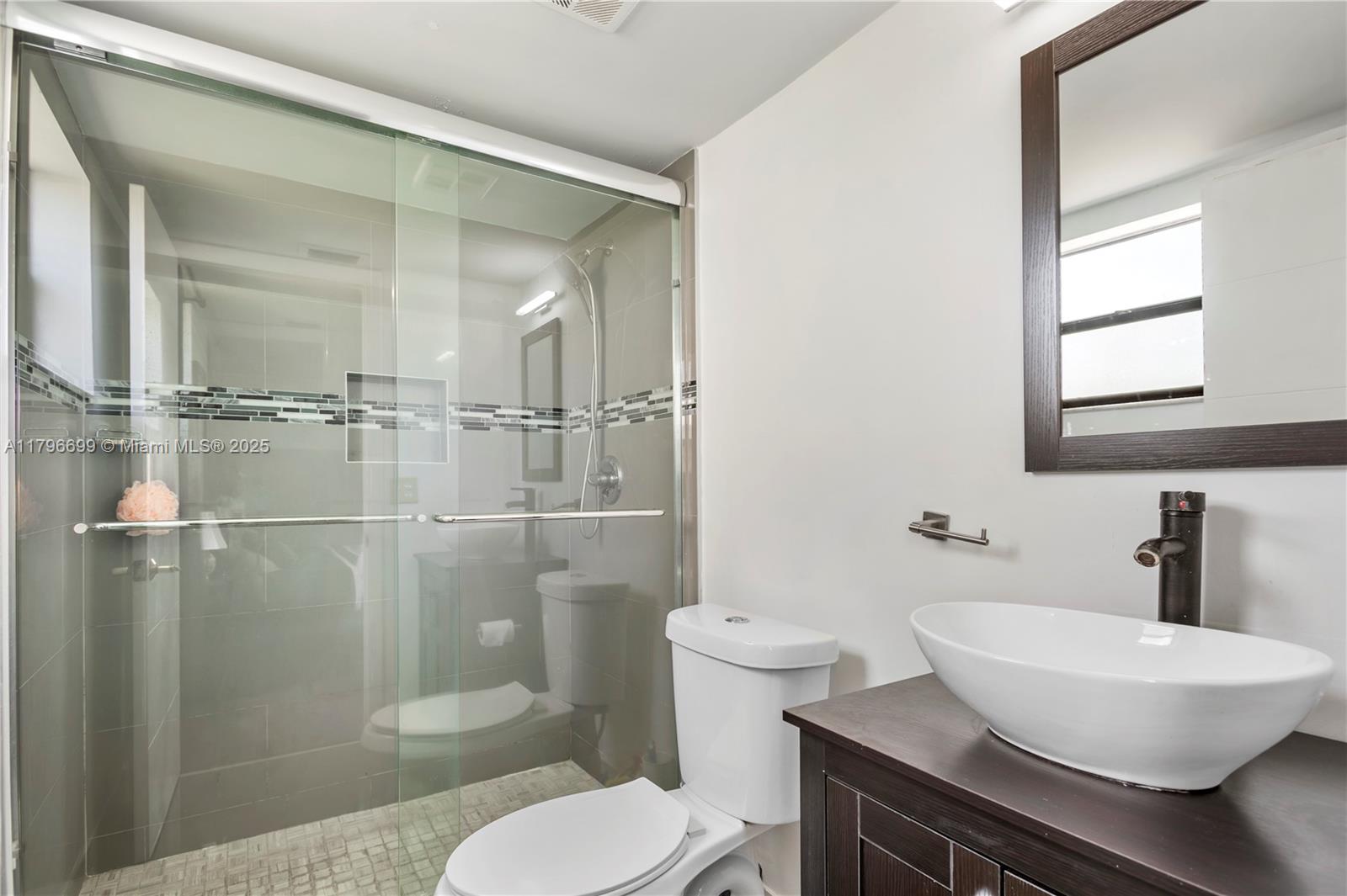 22053 Palms Way, Unit 106 Boca Raton, FL 33433 - Photo 13 of 17 a bathroom with a sink toilet and shower