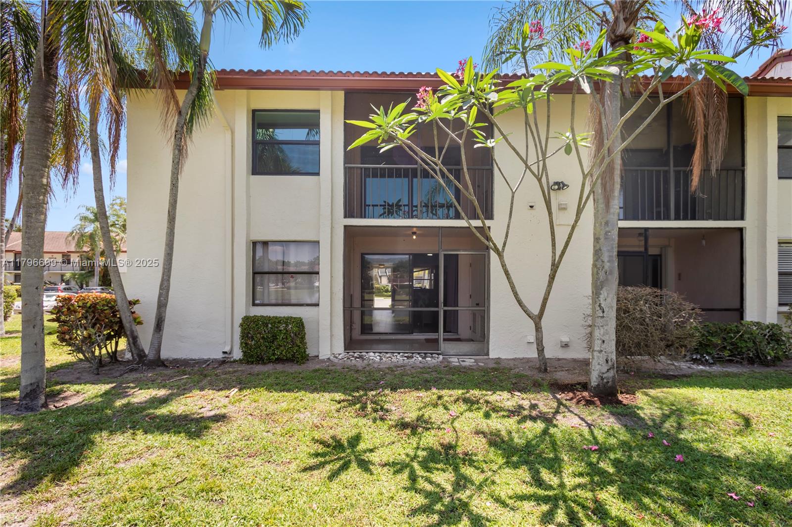 22053 Palms Way, Unit 106 Boca Raton, FL 33433 - Photo 15 of 17 a front view of a house with a yard