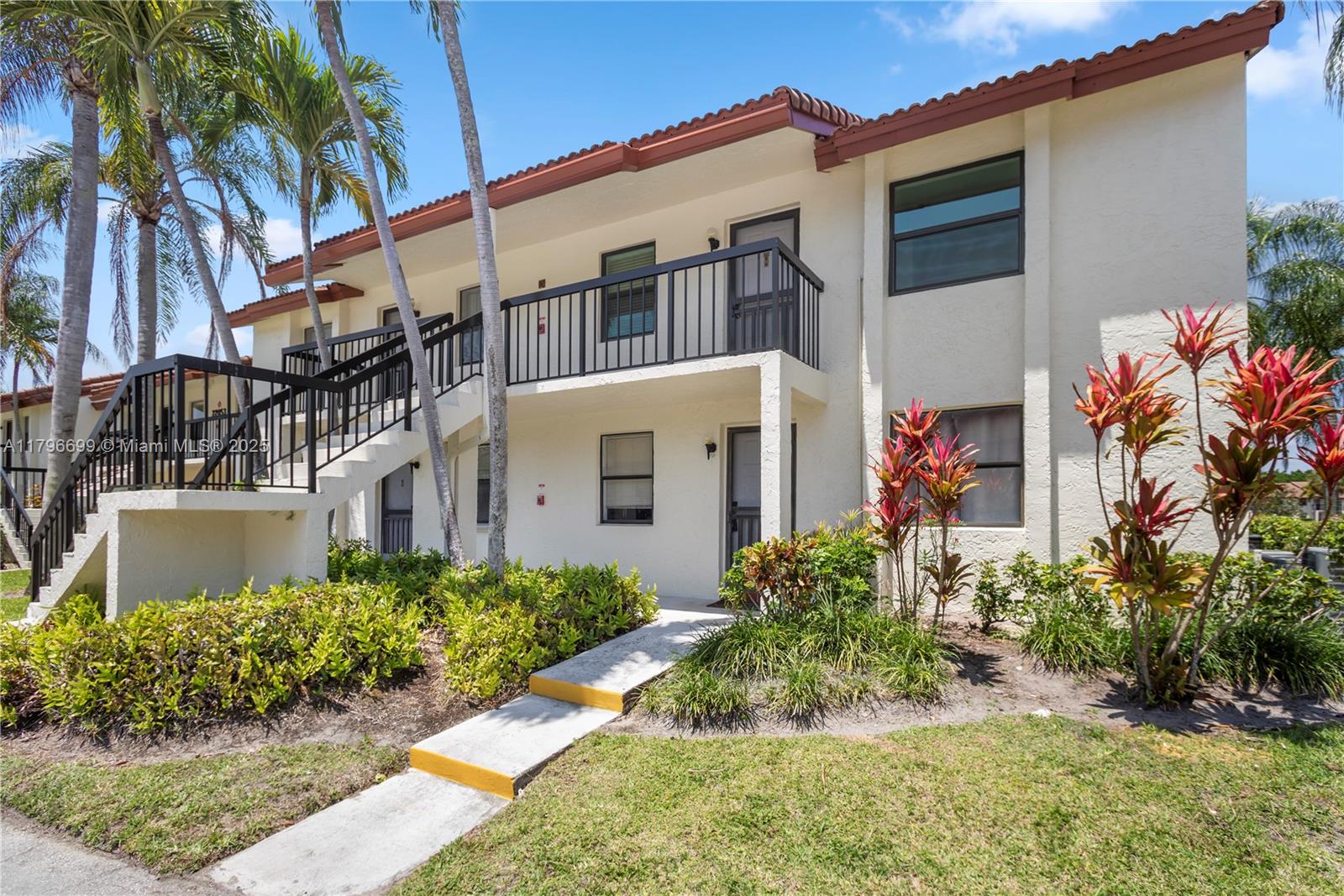 22053 Palms Way, Unit 106 Boca Raton, FL 33433 - Photo 16 of 17 a front view of a house with garden