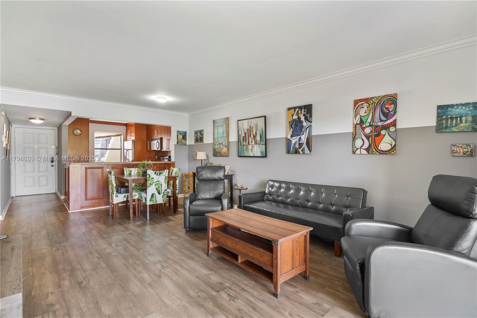 22053 Palms Way, Unit 106 Boca Raton, FL 33433 - Photo 2 of 17 a living room with furniture a wooden floor and a window