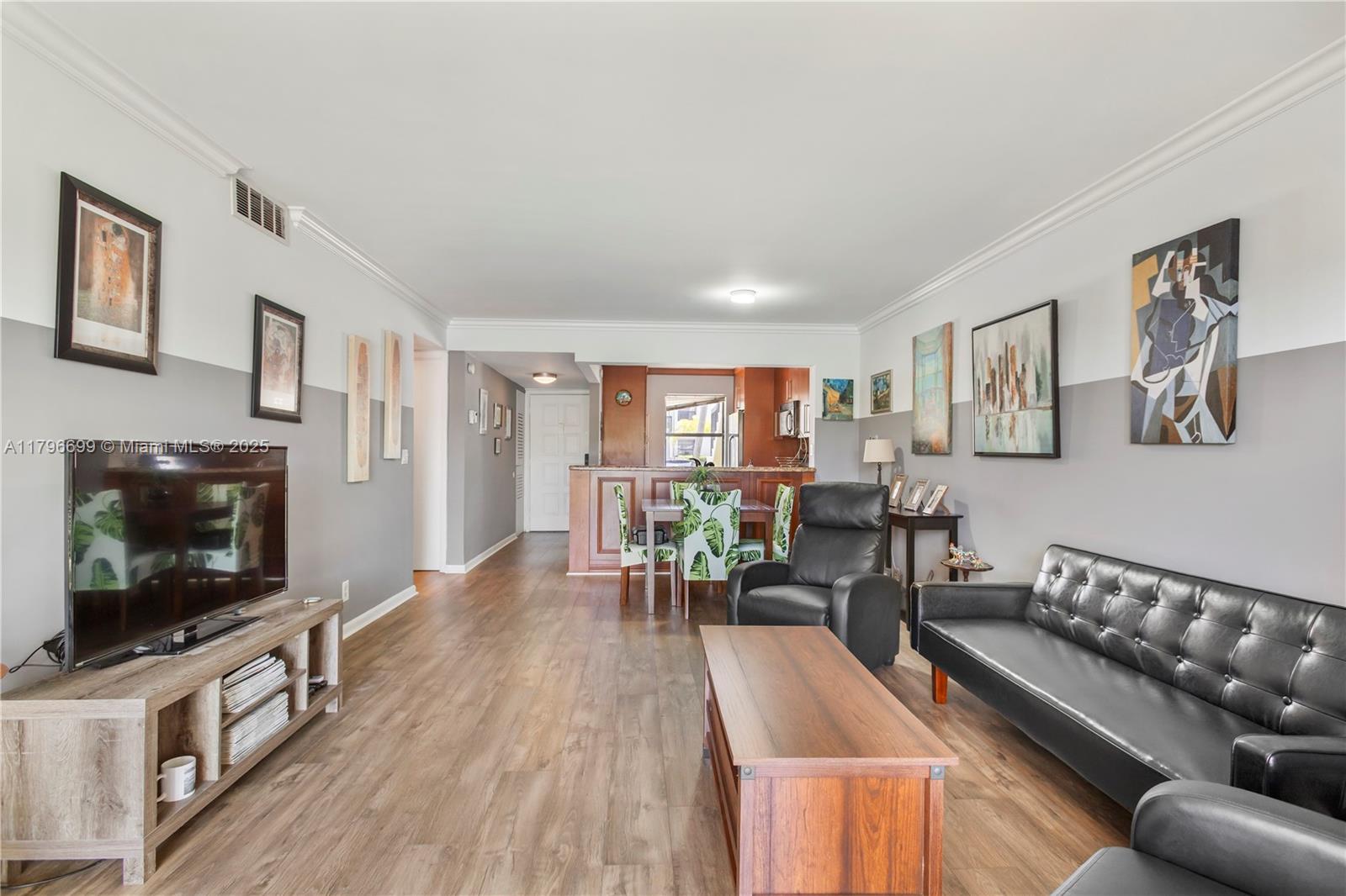 22053 Palms Way, Unit 106 Boca Raton, FL 33433 - Photo 3 of 17 a living room with furniture and a flat screen tv