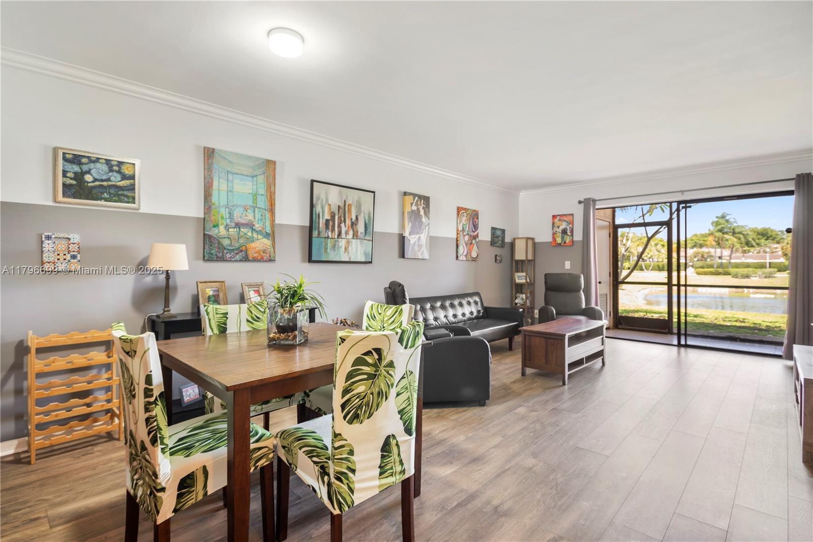 22053 Palms Way, Unit 106 Boca Raton, FL 33433 - Photo 5 of 17 a view of a dining room with furniture a chandelier and wooden floor