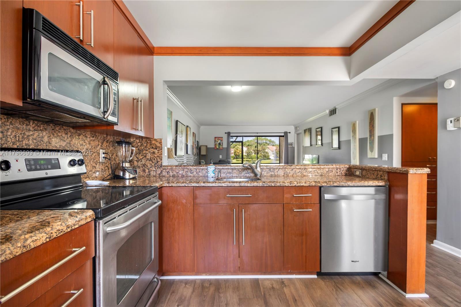 22053 Palms Way, Unit 106 Boca Raton, FL 33433 - Photo 7 of 17 a kitchen with stainless steel appliances granite countertop a stove and a sink