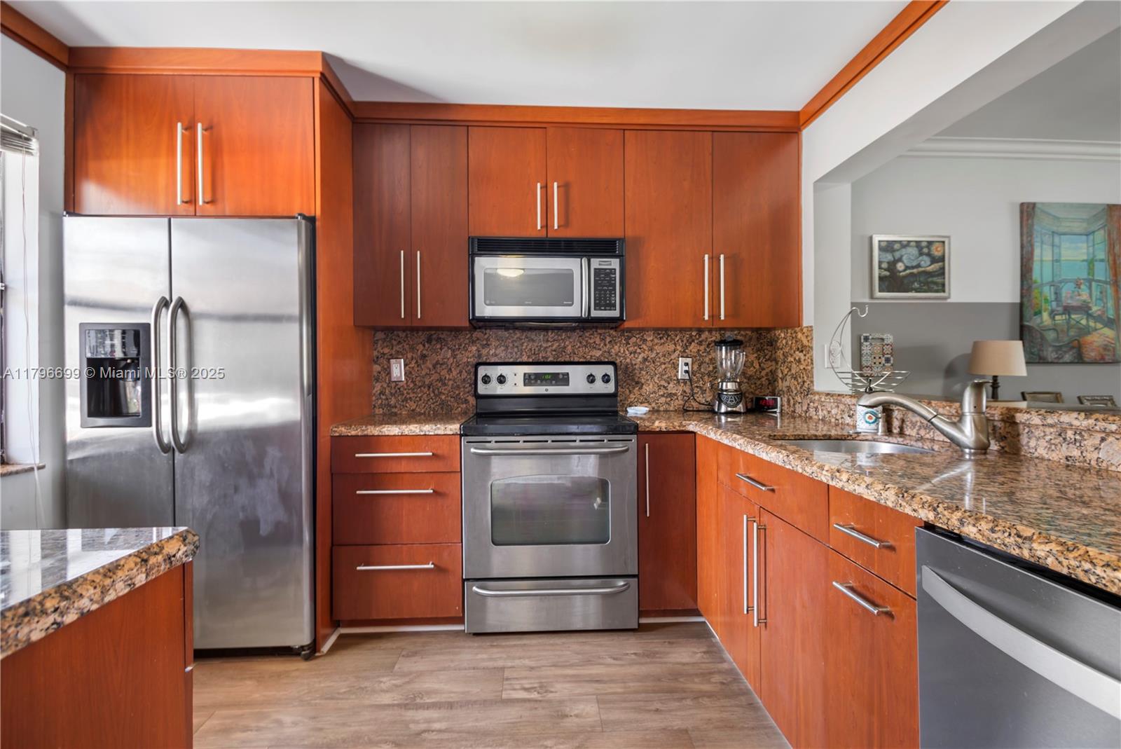 22053 Palms Way, Unit 106 Boca Raton, FL 33433 - Photo 8 of 17 a kitchen with stainless steel appliances granite countertop a refrigerator stove and sink