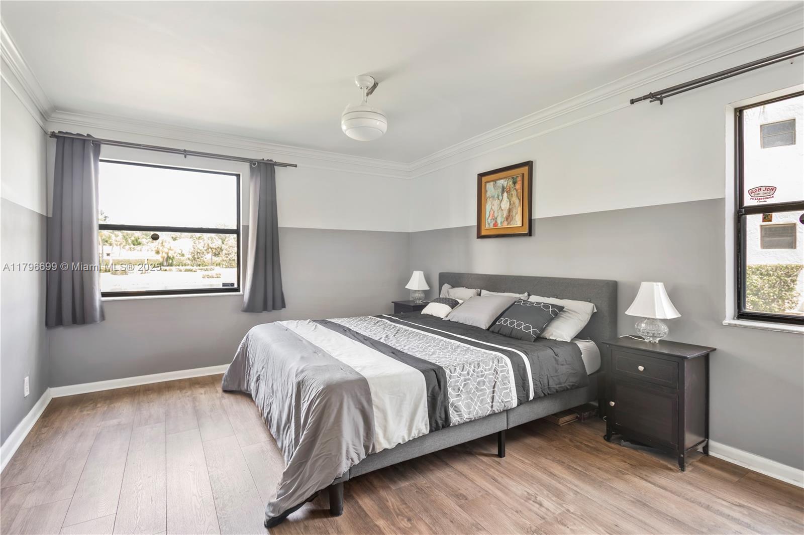 22053 Palms Way, Unit 106 Boca Raton, FL 33433 - Photo 9 of 17 a bedroom with a bed and wooden floor