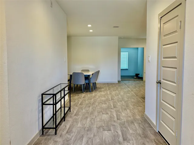 an empty room with a ceiling fan and windows