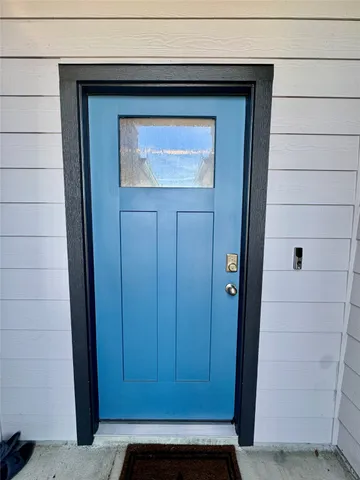 a large kitchen with kitchen island granite countertop a stove top oven a sink a counter space and cabinets