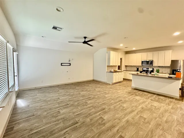 a view of room with furniture and wooden floor